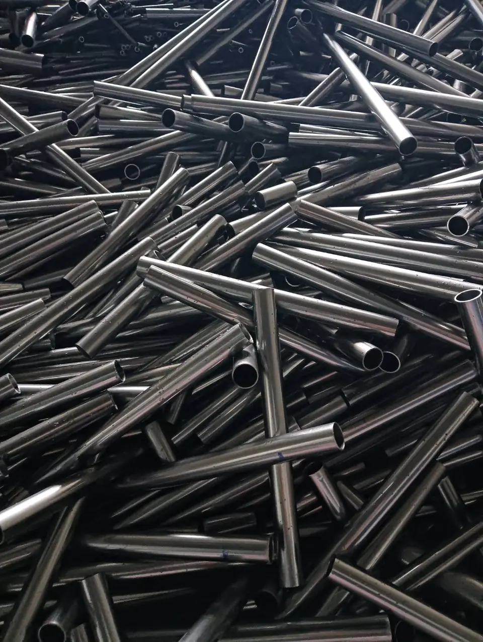 Large pile of cut steel pipes