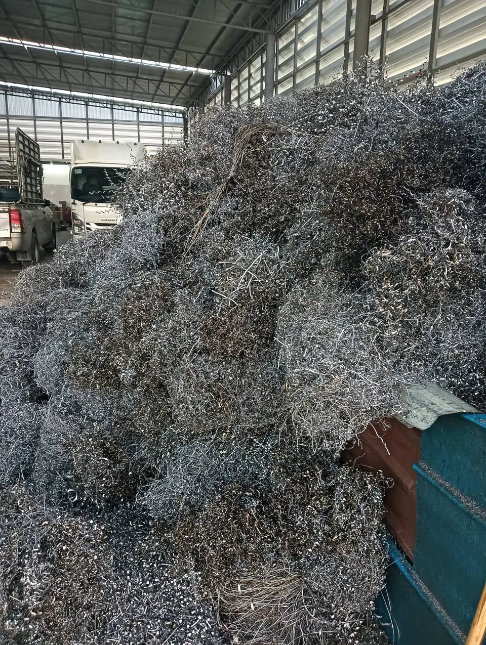 Steel turnings piled in a factory warehouse